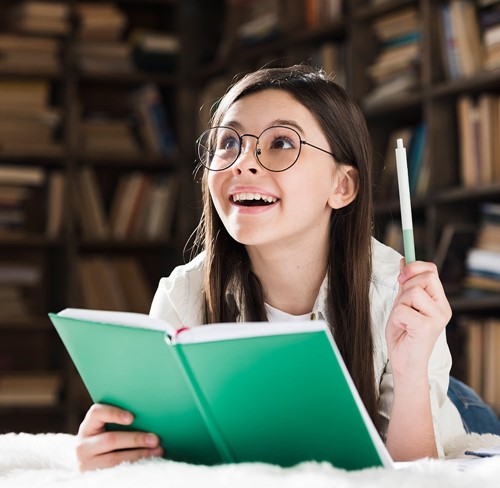 young student in library with a book